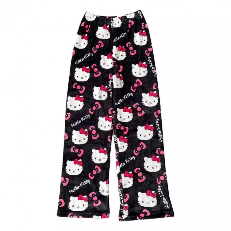 Black Hello Kitty print femboy pants photographed in a flat lay product image, showing a high-contrast Hello Kitty design on soft plush fabric with straight-leg cut against a white backdrop.