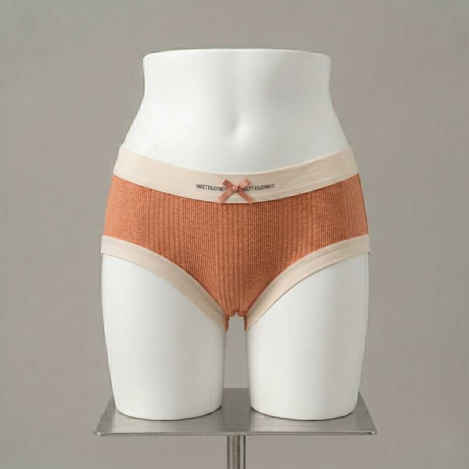Terracotta ribbed modal femboy panties with cream contrast waistband and ribbon bow detail
