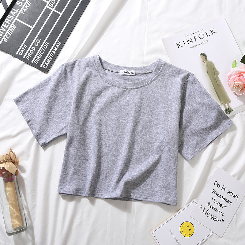 A grey Loose Crop Top Tee displayed on a clean white backdrop with a minimalist theme. The perfect basic piece for femboy outfits, it offers comfort and style in one.