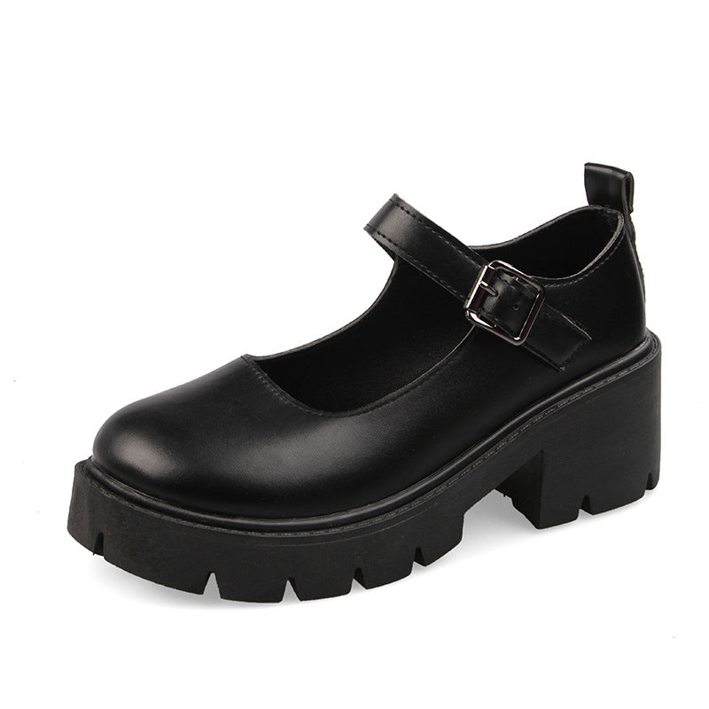 Minimalist black school pumps with a smooth leather design, highlighting the buckle strap and durable sole, a staple in femboy style.