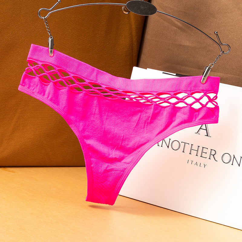 Hot pink fishnet femboy thong displayed on hanger, bold color with cut-out waistband design, fashion studio setup
