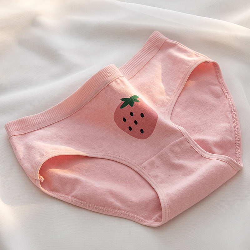 Close-up shot of a pair of pink panties featuring a single strawberry print on the front. The panties are laid out on a white surface with soft natural lighting, emphasizing their breathable cotton material, perfect for femboy clothes and outfits.