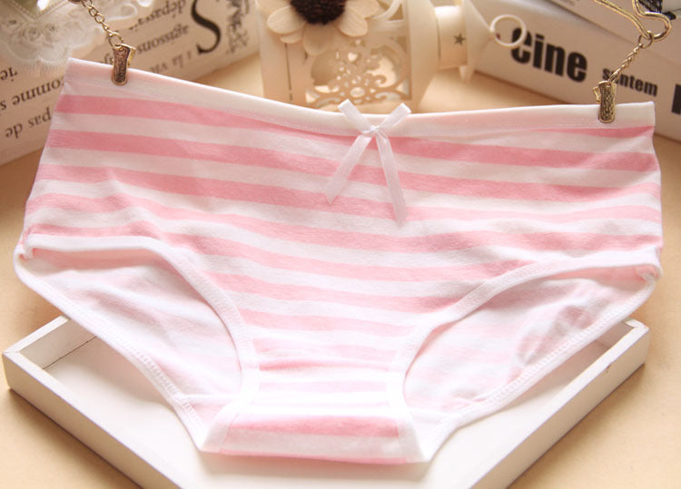 Chic pink and white striped panties with a bow detail, set against a light background. A charming piece for femboy outfits and stylish femboy clothes.