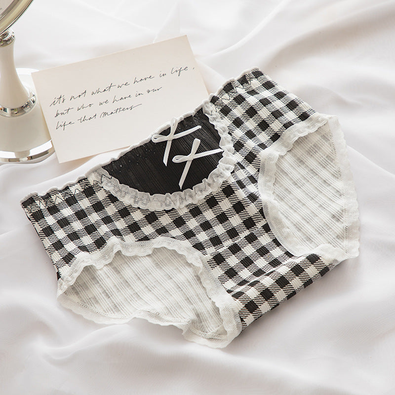 Close-up view of black and white plaid Lolita Bowknot Panties with lace accents, photographed from above, embodying the essence of femboy clothes.