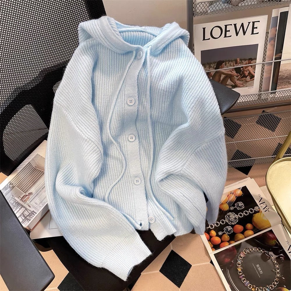 Close-up of a soft knit light blue femboy hoodie with button-up front, styled on a black office chair, perfect for cosy femboy outfits or casual femboy fashion.