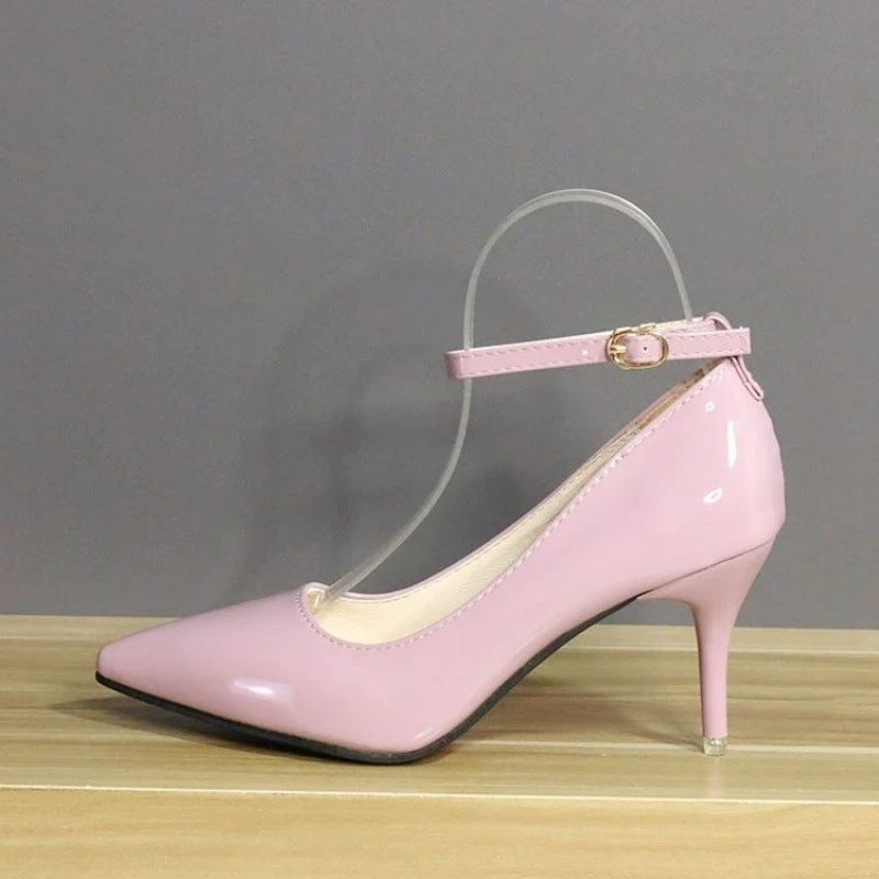 Soft pink leather heels with a feminine touch, adorned with an ankle strap and a glossy finish, tailored for chic femboy fashion statements.