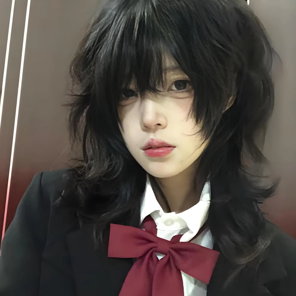 Close-up portrait of a soft wave wolf femboy wig in black, highlighting the textured wolf cut layers, soft waves, and fringe bangs, styled for an anime-inspired femboy fashion look with a smooth, natural finish.