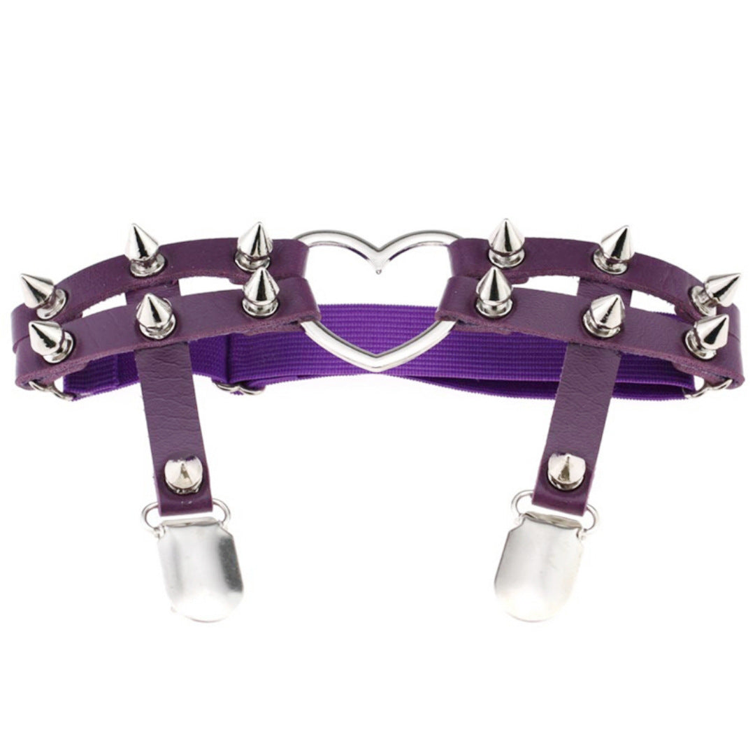 Front-facing studio shot of the purple Studded Heart Femboy Thigh Garter captured at eye level on a clean white background, highlighting deep purple faux leather, silver spike hardware, adjustable thigh straps, and a central heart ring, perfect for gothic and aesthetic femboy outfits.