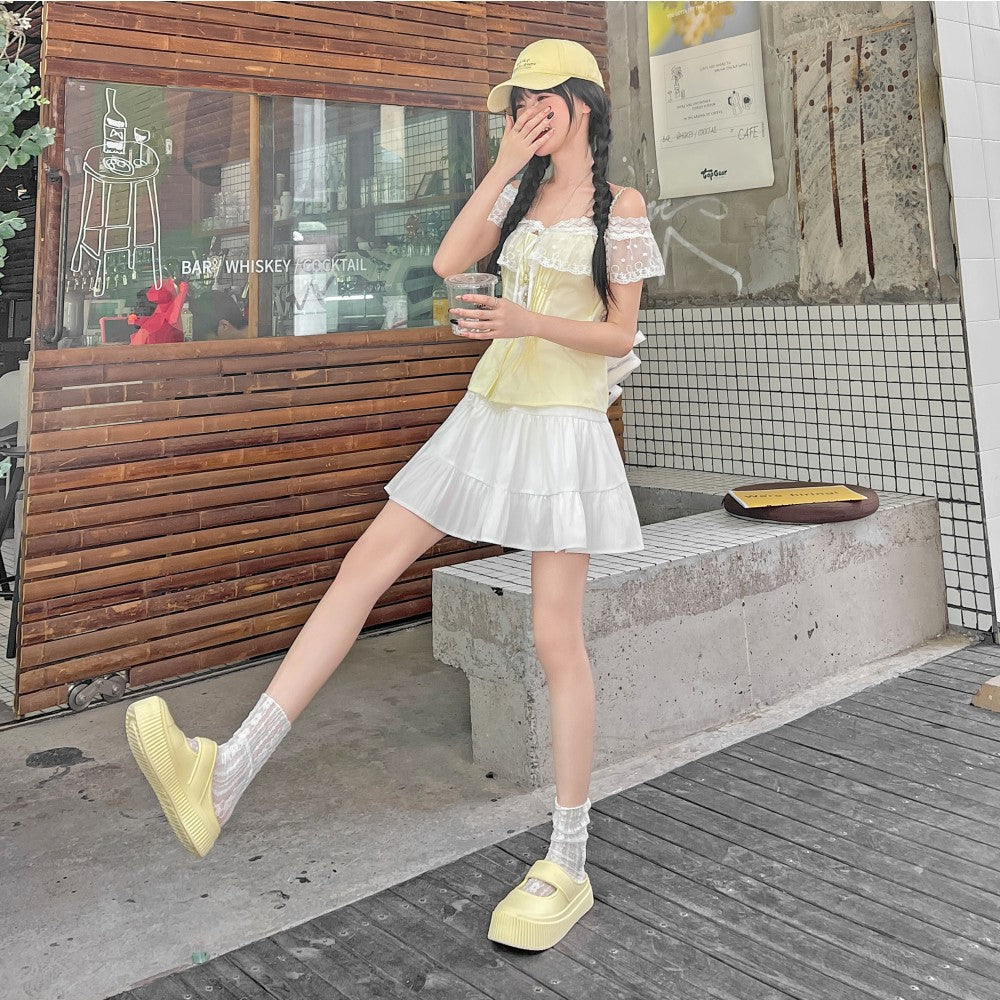 White tiered ruffle mini skirt street style lifestyle shot, high waist A-line femboy skirt