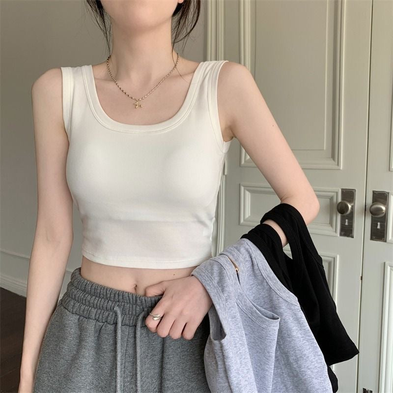 Front-facing shot of the Padded Short Camisole in white, styled with grey joggers for a relaxed and modern look. A stylish addition to femboy fashion and comfortable femboy clothes.